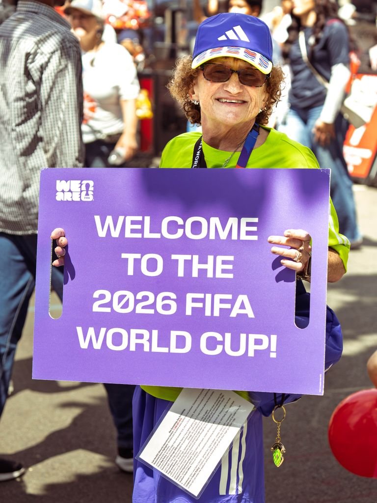 A person holds a sign welcoming the 2026 FIFA World Cup in Seattle.